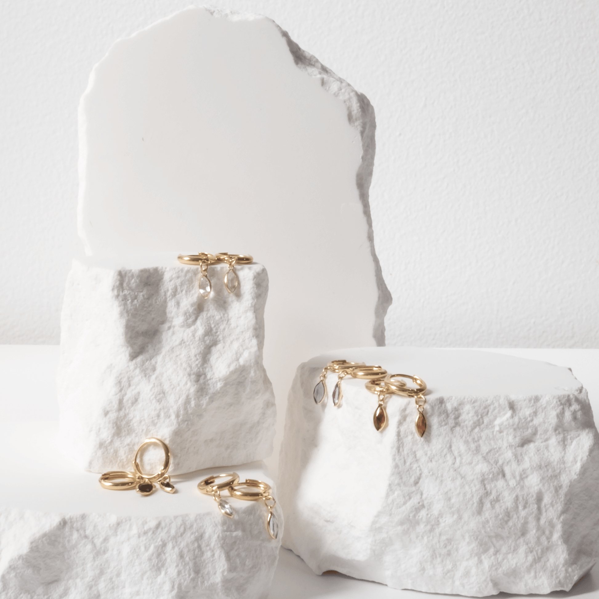 Gold rings displayed on a textured white surface