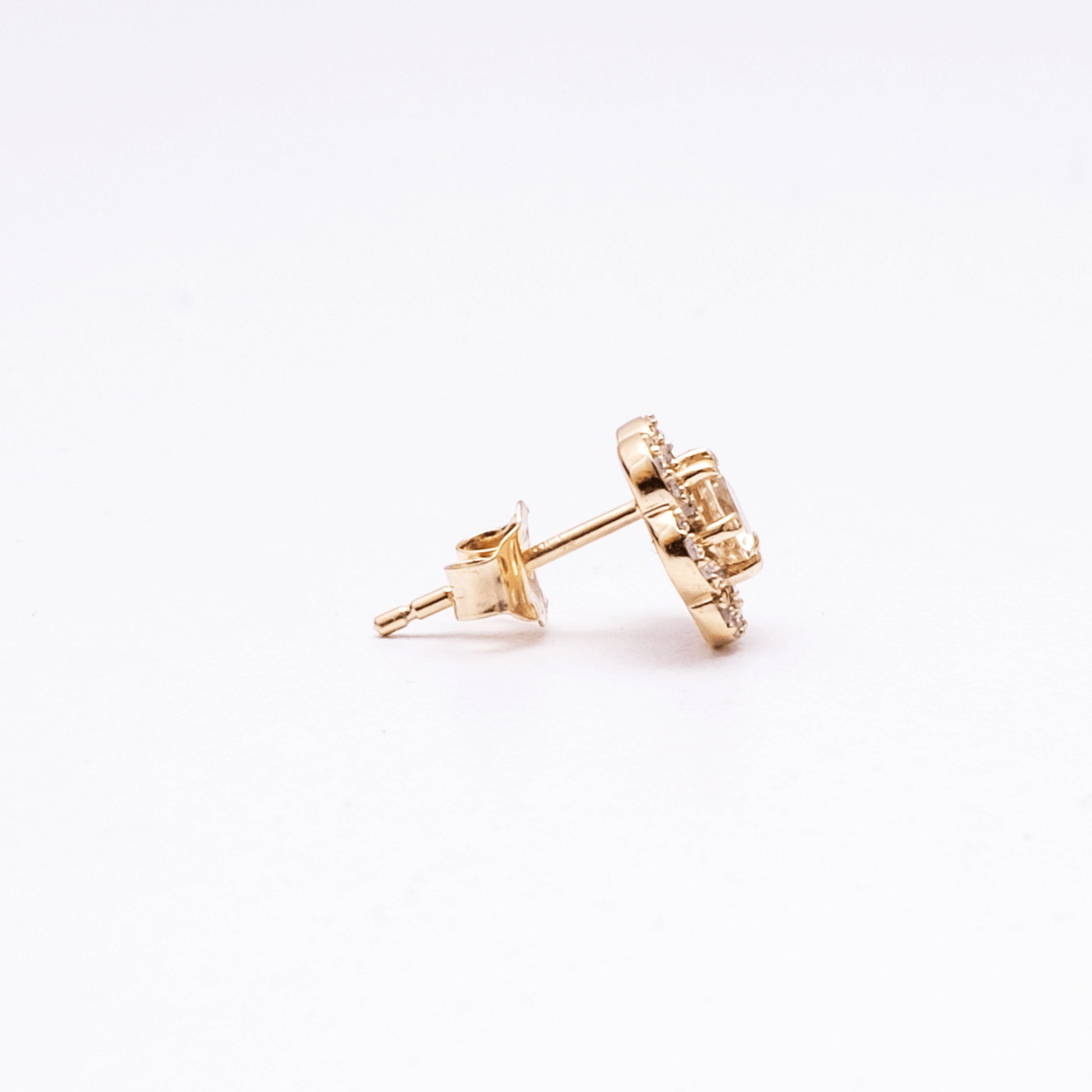 Gold stud earrings on a white background