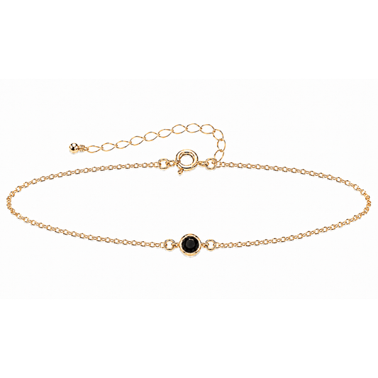 Gold bracelet with a BLACK SPINEL gemstone on a white background