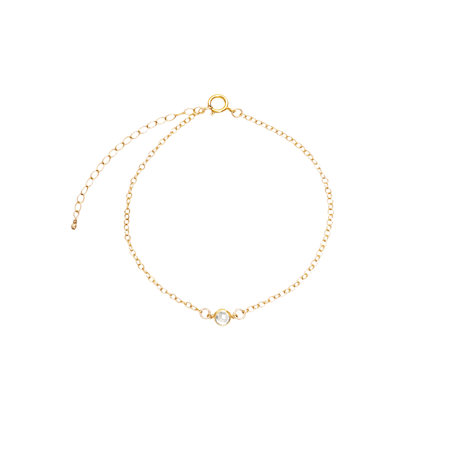 Gold bracelet with a small round gemstone on a white background