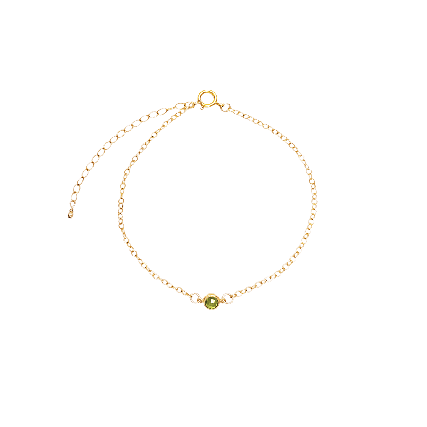 Gold bracelet with a small green gemstone on a white background