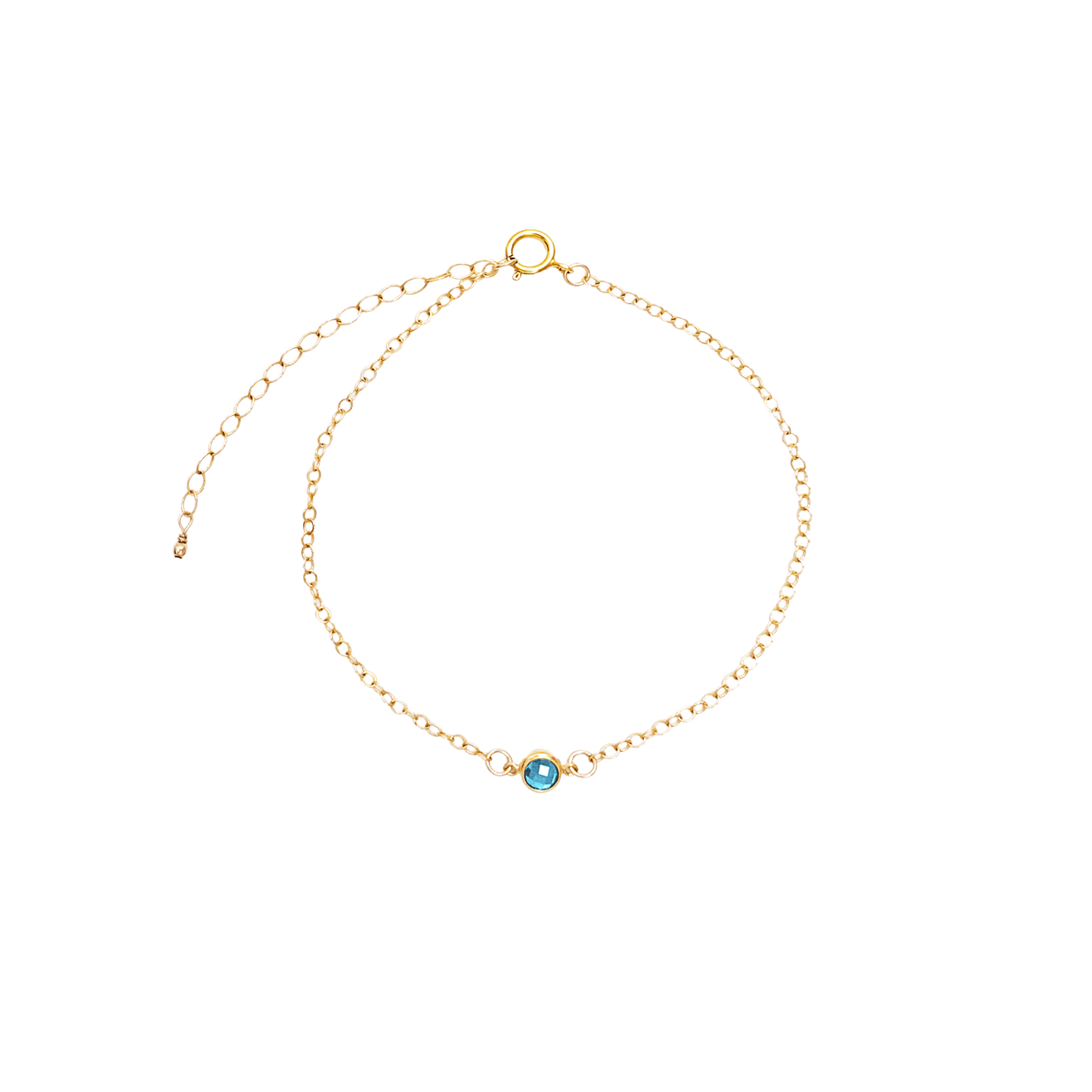 Gold bracelet with a blue gemstone on a white background