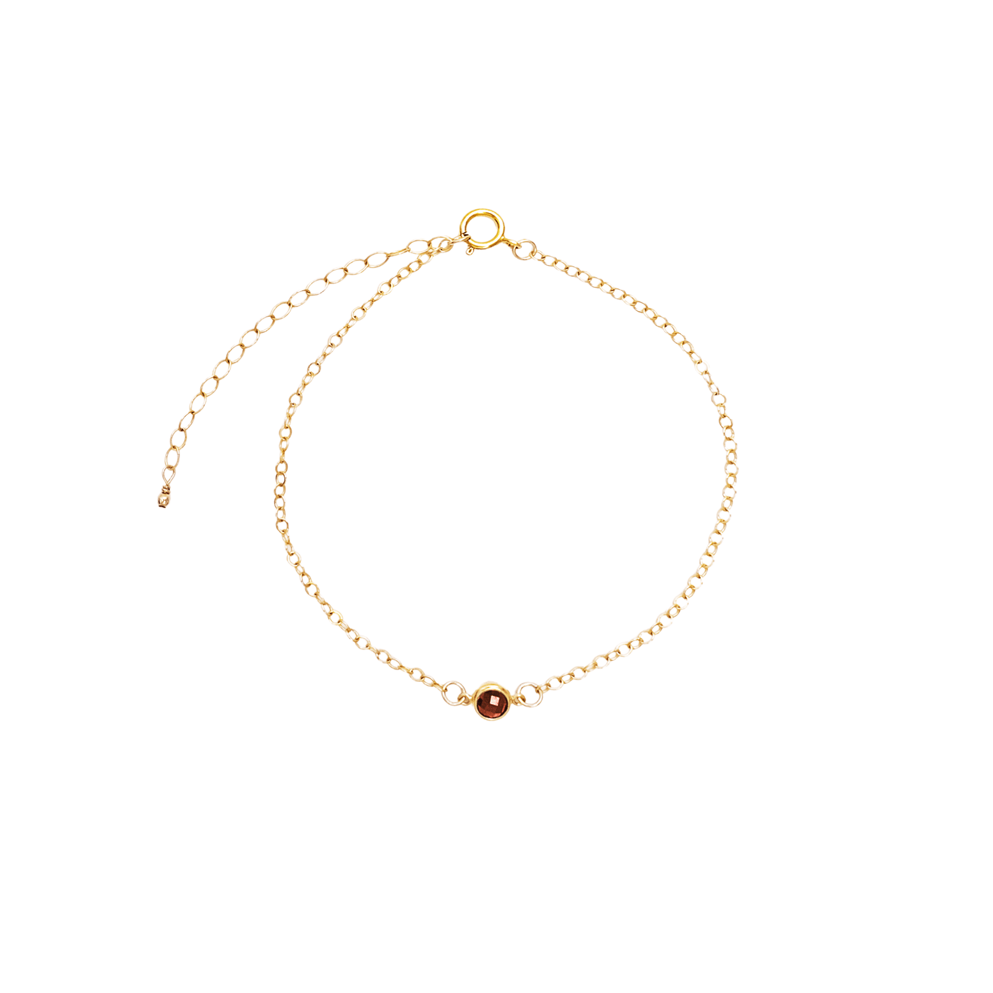 Gold bracelet with a small round gemstone on a white background