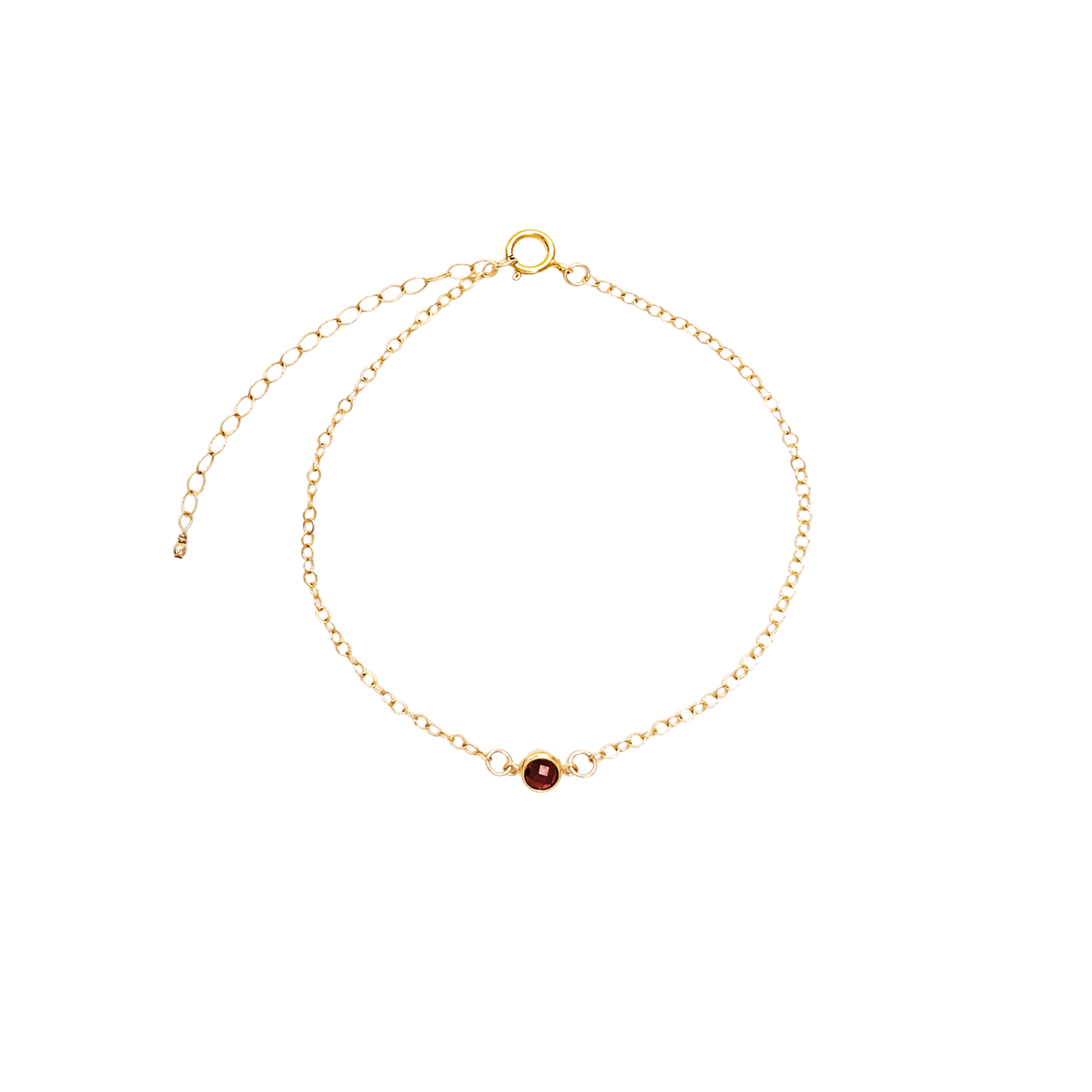 Gold bracelet with a red gemstone on a white background
