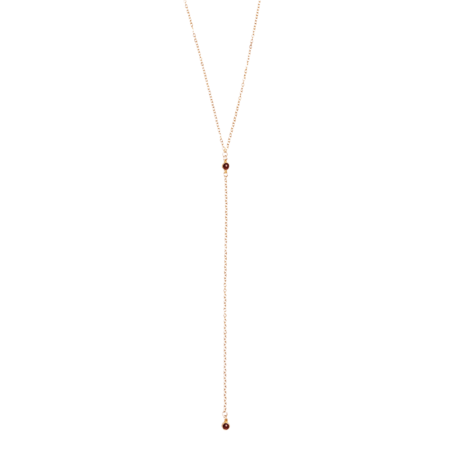 Long gold necklace with small beads on a white background