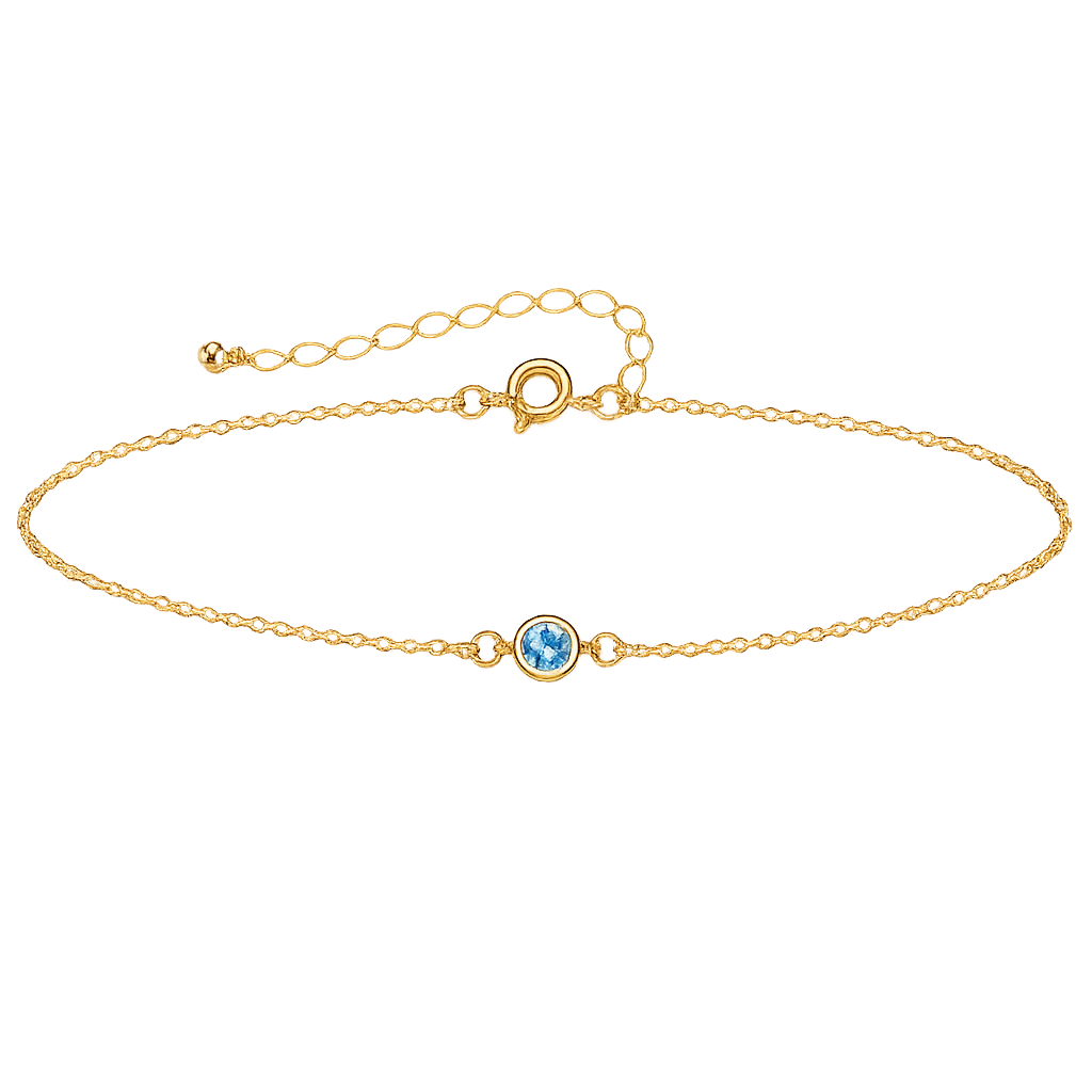 Gold bracelet with a small gemstone on a white background